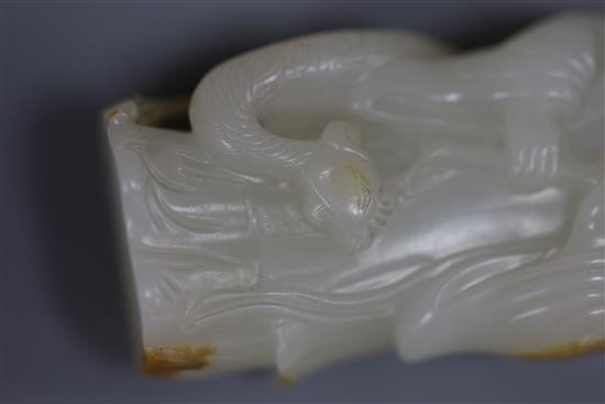 A fine Chinese white and russet jade group of Xi Wangmu and a phoenix, 19th/20th century, 9.5cm high, wood stand